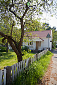 Rustic fence around garden of small wooden house