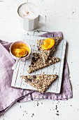 Vegan crispbread triangles with seeds and apricot jam