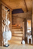 Staircase, tree-style coat rack and fur shoulder bags in dacha