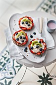 Vegan mini tarts with fruits and vanilla cream