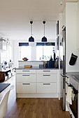 Black and white kitchen with living room beyond counter