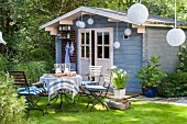 Idyllic seating area with many lanterns in front of summer house