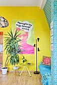 Dracaena in living room with one bright yellow and one patterned turquoise wall