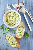 Garlic bread and herb butter on a blue wooden background
