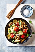 Wholegrain penne with cherry tomatoes, zucchini and challots