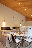 Seating area on roofed terrace with black and white accents