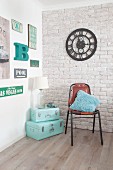 Mint-green suitcases in corner below retro signs and clock on walls