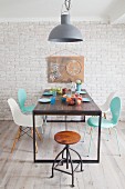 Classic chairs around table and hand-made artwork with cogs on wall