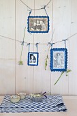 Old photos with crocheted picture frames hung from lines