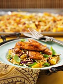 Thai chicken tenders with coleslaw and pineapple from a baking tray
