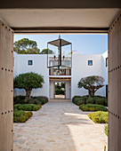View into Mediterranean courtyard through open doors