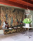 17th-century Flemish tapestry, wooden bench and table under French 19th-century glass chandelier