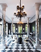 Mirrored pillars, billiards table, round glass table and classic designer pieces