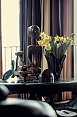 Daffodils and various ethno figures on coffee table