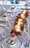 A festively set table with a Christmas candle decoration