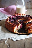 Cherry yeast cake with a slice cut out