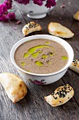 Cream of mushroom soup topped with truffle oil and freshly ground pepper, served with little pastry parcels