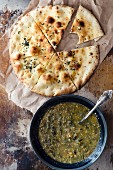 Spinach soup and a flatbread (seen from above)