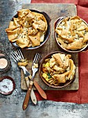 Three individual servings of curried chicken pie