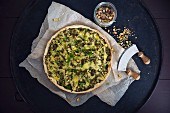 A vegan spinach and potato quiche with pistachios and plant-based cheese
