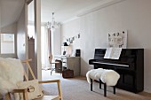Sheepskin on piano stool, black piano and vintage desk and office chair