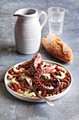Octopus salad with beans, cucumber, onion and parsley