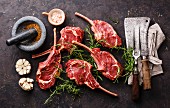 Raw fresh meat veal ribs, spices and vintage kitchen utensils on dark background