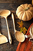 Fall diner celebration in the country, wooden spoons with leaves and pumpkin