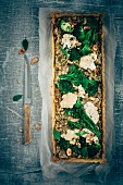 Broccoli, bimi and cauliflower tarte, almonds, fresh thyme and fresh basil leaves