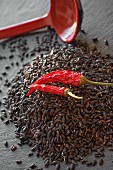 A pile of black rice with dried chillies