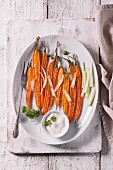 Baked carrots with olive oil, herbs, custardery and yoghurt