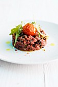 Lamb tartare with cherry tomatoes and rocket