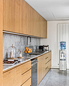 Simple kitchen with wooden cabinets and marble worksurface