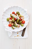 Basil gnocchi with cherry tomatoes and white beans