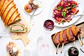 A Christmas meal with salmon en croûte, loin of venison, red cabbage and baked apple