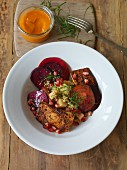 Vegan couscous bowl with baked tofu and beetroot