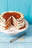 Tiramisu cake with peaches and almond flakes