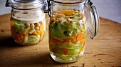 Fermented pointed cabbage with carrot and pepper in preserving jars