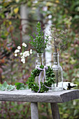 Small box wreath and twigs in two glass bottles
