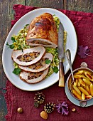Roast turkey stuffed with baked fruits on a bed of savoy cabbage