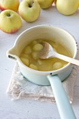 Apple compote cooking in a saucepan