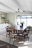 Drop-leaf table in bright dining area in front of kitchen counter