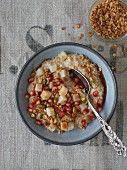 Vegan porridge with pear, pistachios and pomegranate seeds