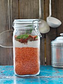 Dal mix with red lentils and coconut in a storage jar