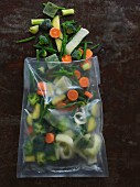 Frozen vegetables with herb and oil ice cubes