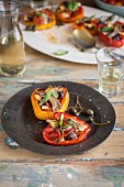 Stuffed peppers with tomatoes, anchovies and capers