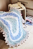 Crocheted, oval, rag-yarn rug in shades of blue