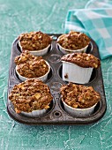 Apple and coconut muffins in a muffin tray