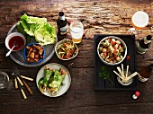 Various starters, salad and beer on a wooden table