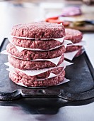 Stack of raw lean ground beef hamburger patties
